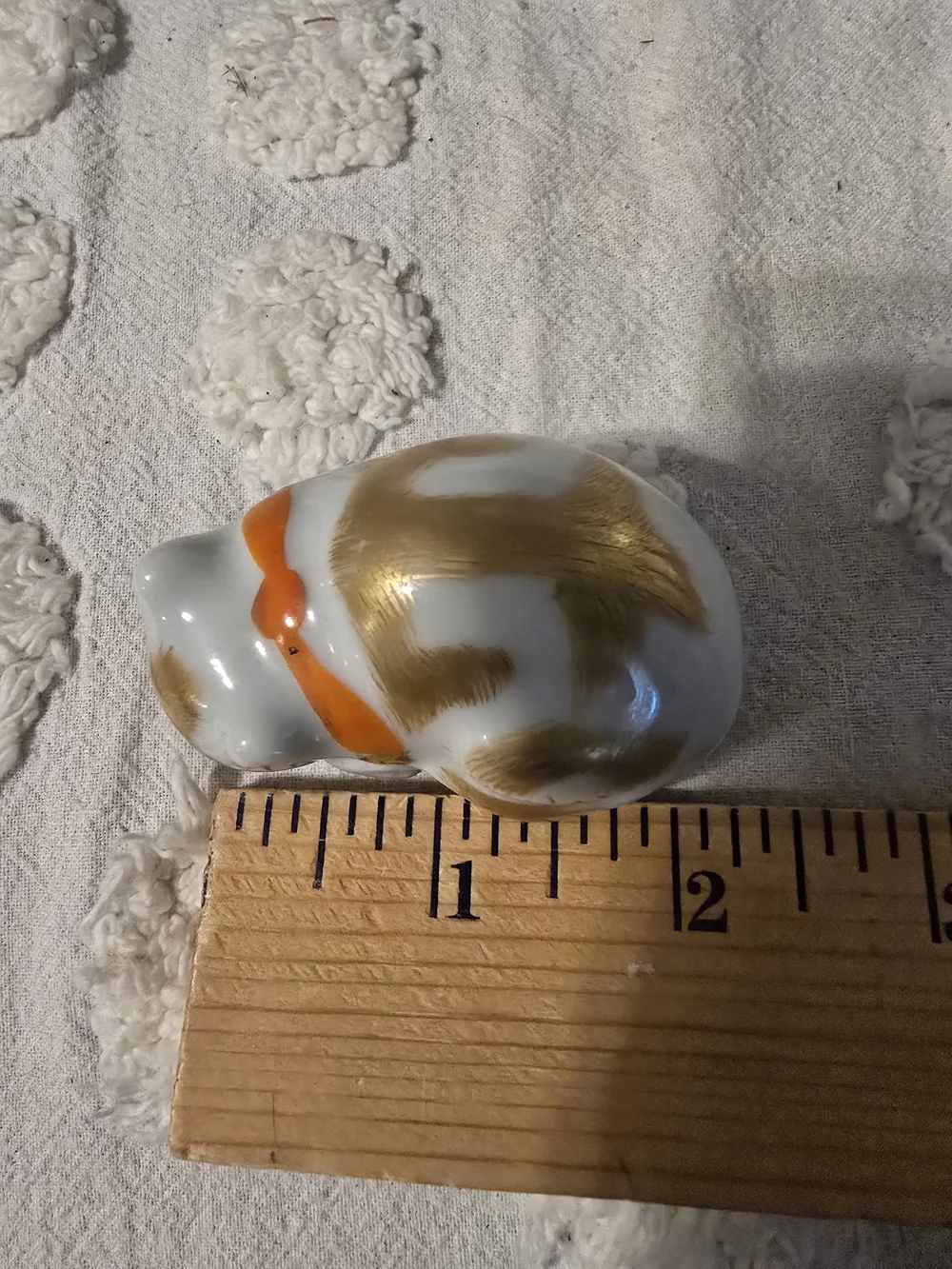 White Ceramic Sleeping Cat Figurine with Gold Accents and Orange Collar